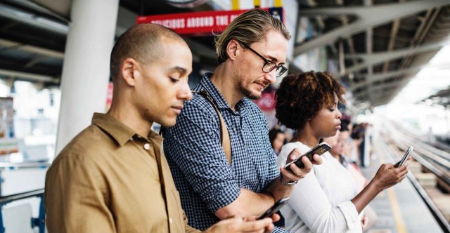 three person holding smartphones